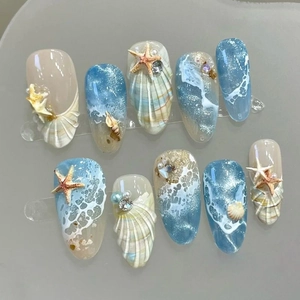 Handmade ocean theme press-on nails with 3D seashells, blue ocean waves and tiny pearls