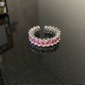 Detailed view of adjustable silver ring with rectangular pink gemstones in a row