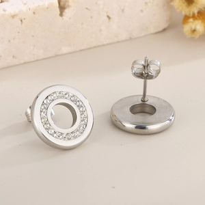 Macro shot of silver circular stainless steel stud earrings with shimmering rhinestones
