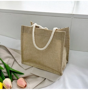 Detail of natural linen tote bag with white cotton rope handle and polka dot lining