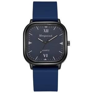 Detail of square quartz watch featuring a navy silicone strap and black metallic case