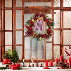 Christmas wreath with red berries and pine cones on a rustic wooden window sill decoration