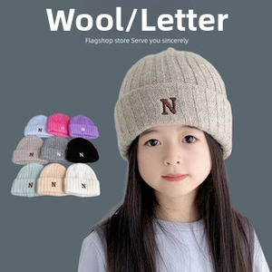Close-up of wool-blend kids beanie with embroidered N letter in various colors