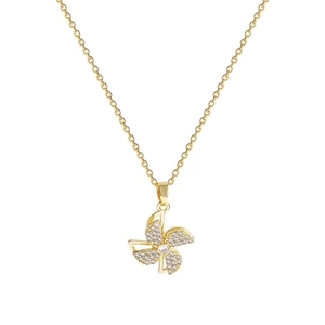 Golden windmill necklace with sparkling zircon pavé crystal pendant on white background