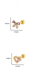 Detail of gold-plated cartilage studs with purple bow and pink heart zircon stones
