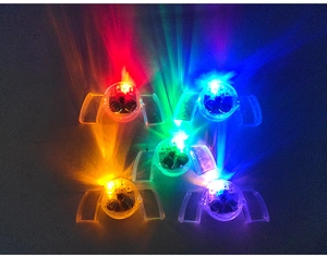 Detail showing five-piece set of colorful flashing LED mouthpieces with inner battery components