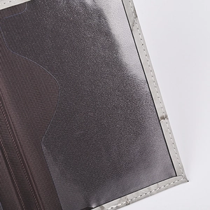 Macro view of marble PU passport cover showing grey twill fabric and clear PVC pocket