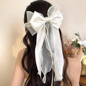 Elegant large white mesh bow hair clip with long silk ribbons for women's hairstyles