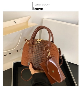 Detailed view of brown crocodile texture handbag set with a matching small glossy pouch