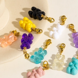 Colorful resin bear pendants with golden lobster clasps on a clean white background