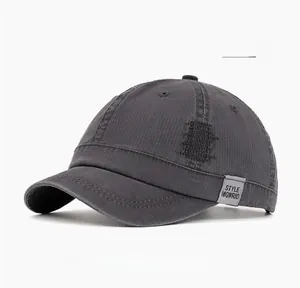 Detail of gray washed cotton baseball cap featuring vintage distressed fabric and woven label