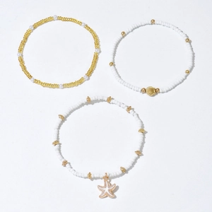 Three-piece bohemian beaded anklet set featuring starfish and seashell gold pendants