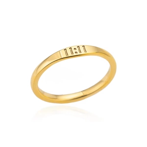 Close-up of golden stainless steel ring featuring 11:11 angel number engraved detail