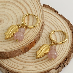 Stainless steel gold leaf earrings with pink natural stones on rustic wood slices