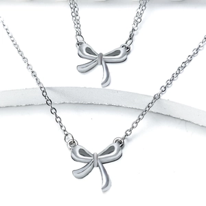 Elegant silver bow pendant necklace set with high-gloss polished metal finish