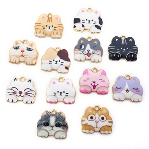 Detailed view of twelve colorful cat-shaped enamel alloy pendants for DIY jewelry