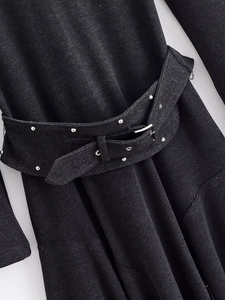 Detail of denim dress waist belt featuring silver studs and metallic buckle