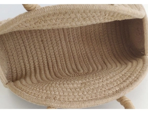 Close-up of natural beige woven tote bag showing internal spiral weaving craftsmanship