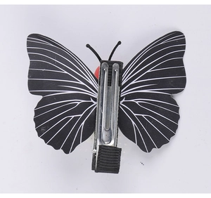 Detail of the silver metal alligator clip with black fabric on a butterfly hairpin