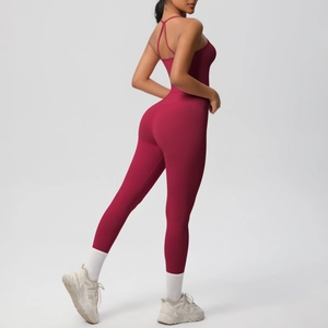 Detail of burgundy backless yoga jumpsuit featuring cross straps and slim fit silhouette