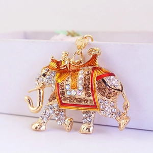 Sparkling rhinestone running elephant keychain with golden finish and enamel details