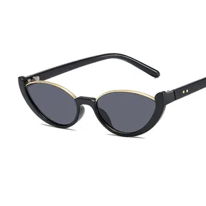 Cat eye semi-rimless sunglasses in black and gold with dark lenses and rivet detail