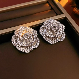 Vue macro des boucles d'oreilles fleur argentée avec strass dans une boîte à bijoux de luxe