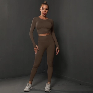 Detail of seamless dark brown yoga set featuring long sleeves with thumb holes and high waist