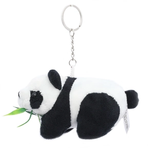 Plush panda keychain holding green bamboo leaves with metal ring on white background