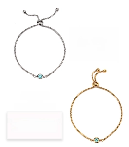 Detail of gold and silver adjustable chain bracelets with December tanzanite birthstones