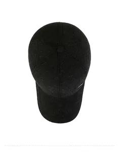Top view of thick wool blend baseball cap with metallic logo and textured fabric