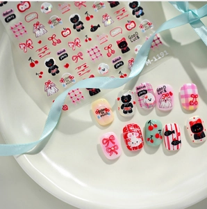 Detailed view of cartoon rabbit and animal nail art stickers with finished nail samples