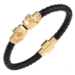 Men's punk leather bracelet with gold skull accents and magnetic clasp on white background
