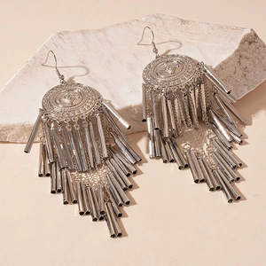 Vintage silver round stud earrings with long metal tassels on light textured stone