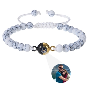 Detail of custom photo projection bracelet with marble beads and couple photo display