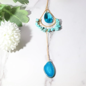 Detail of blue agate slice and turquoise beads suncatcher with golden crescent moon charm