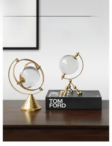 Detail view of modern gold iron ornaments with crystal balls on a wooden tabletop