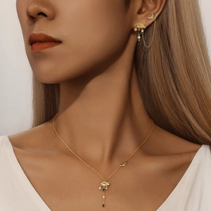 Model wearing golden star, moon and cloud jewelry set with blue zircon accents