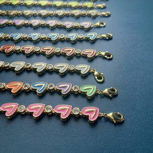 Detail of colorful enamel heart bracelets with gold plating and cubic zirconia accents