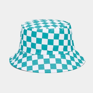 Detailed view of the green and white checkered pattern on a double-sided bucket hat