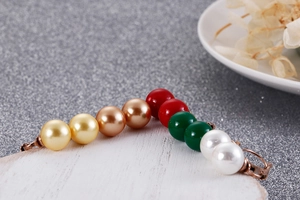 Détail macro de perles colorées et lien en bronze vintage sur boucle d'oreille