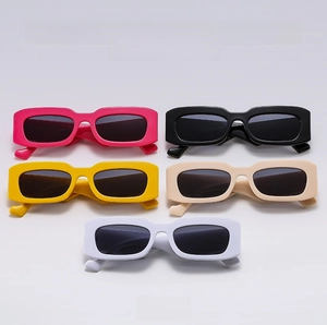 Flat lay of retro rectangular sunglasses in pink, black, yellow, beige and white