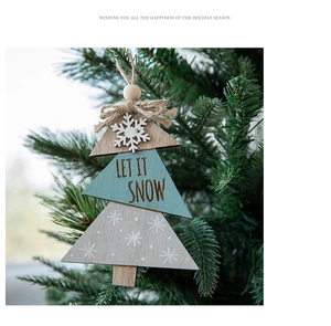 Close-up of wooden Christmas tree hanging ornament with Let It Snow text and snowflakes