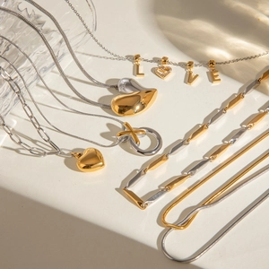 Elegant gold and silver heart pendant necklace set with LOVE and XO charms for women