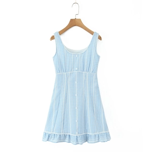 Detail of light blue plaid sundress with white buttons and ruffled hemline finish