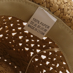 Detail of internal wash label showing 100% paper material for the summer straw hat