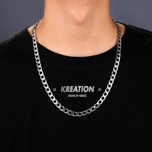 Titanium steel Cuban chain necklace in silver finish worn by a model on a gray background