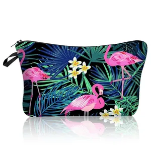 Close-up of tropical flamingo and palm leaf print on a polyester zipper cosmetic bag