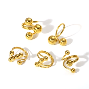 Set of minimalist geometric gold-plated stainless steel rings with sphere details