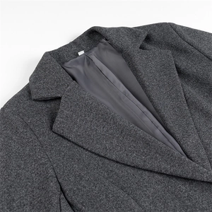 Detail of gray wool coat collar showing fabric texture and smooth inner lining
